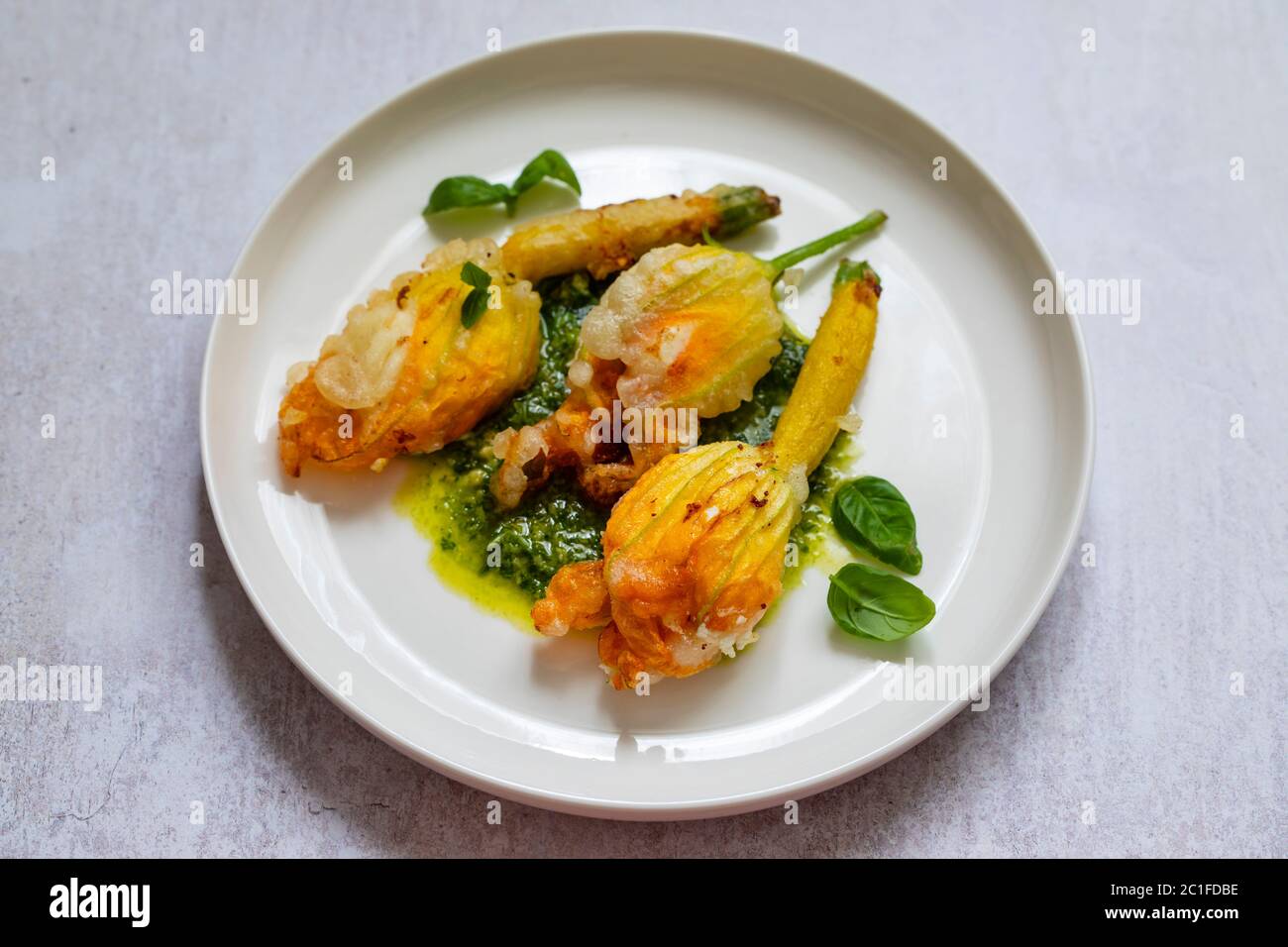 Fried courgette flowers stuffed with ricotta cheese in light tempura batter  Stock Photo - Alamy