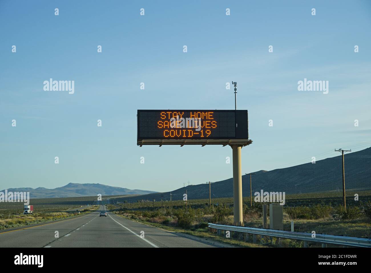 stay home save lives Covid 19 electronic sign on highway 395 in California Stock Photo