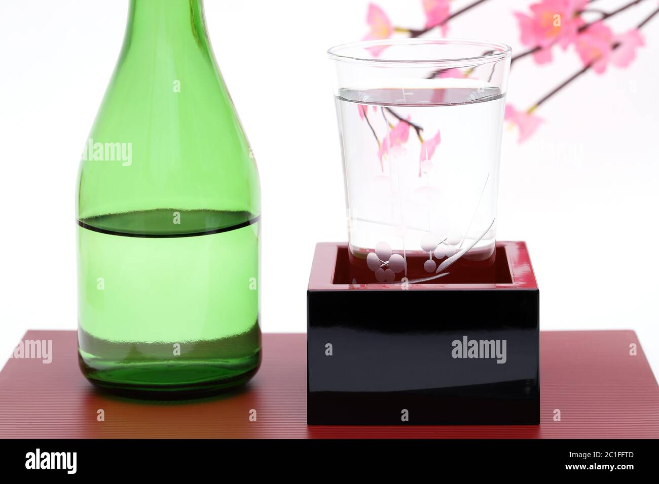 japanese wooden box masu with sake isolated on white background Stock