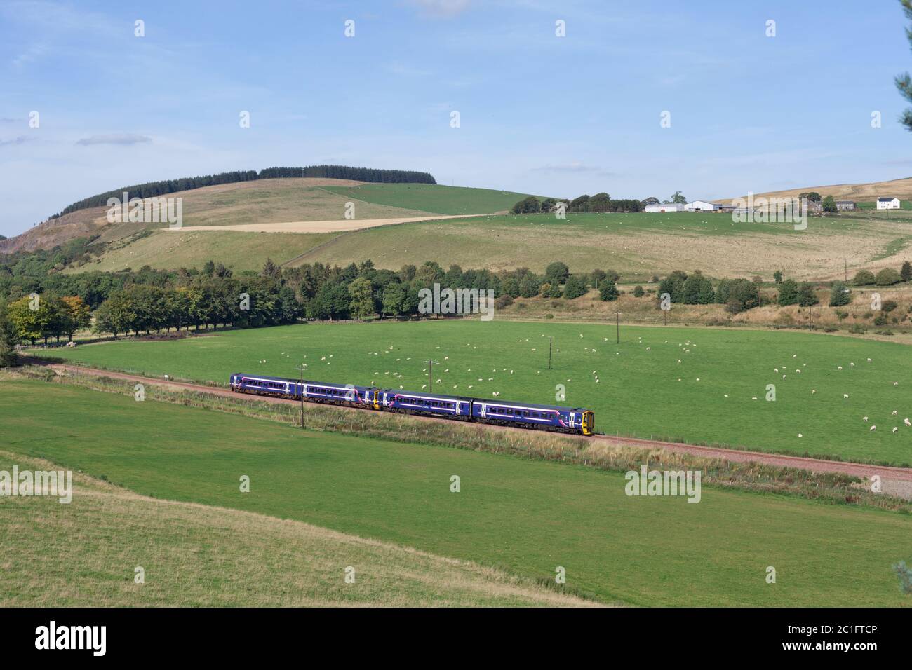2 Scotrail class 158 express sprinter trains passing the countryside at