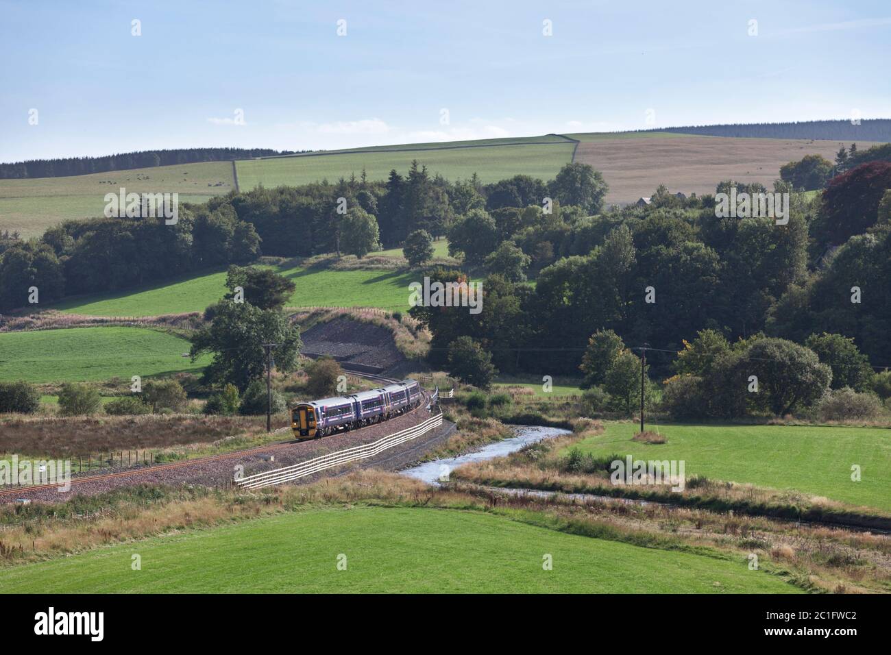 2 Scotrail class 158 express sprinter trains passing the countryside at