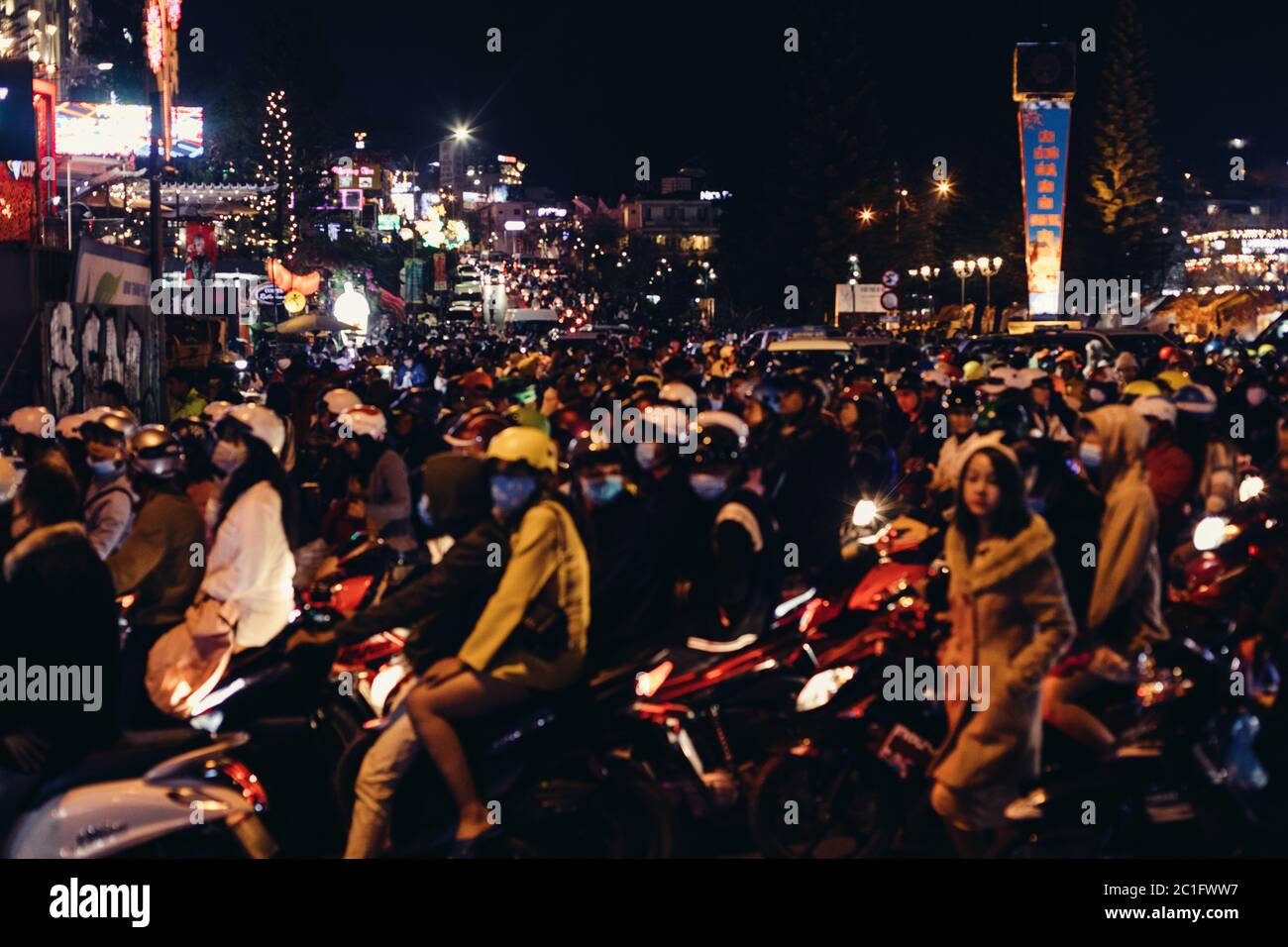 Hundreds of people riding scooters at night in Da Lat, Vietnam Stock Photo