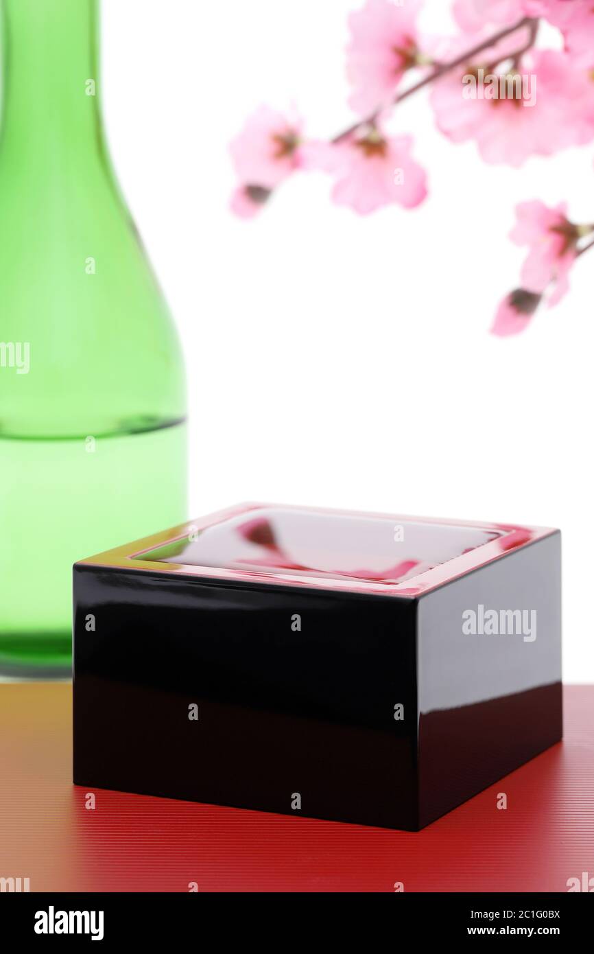 Japanese wooden box masu with sake isolated on white background Stock