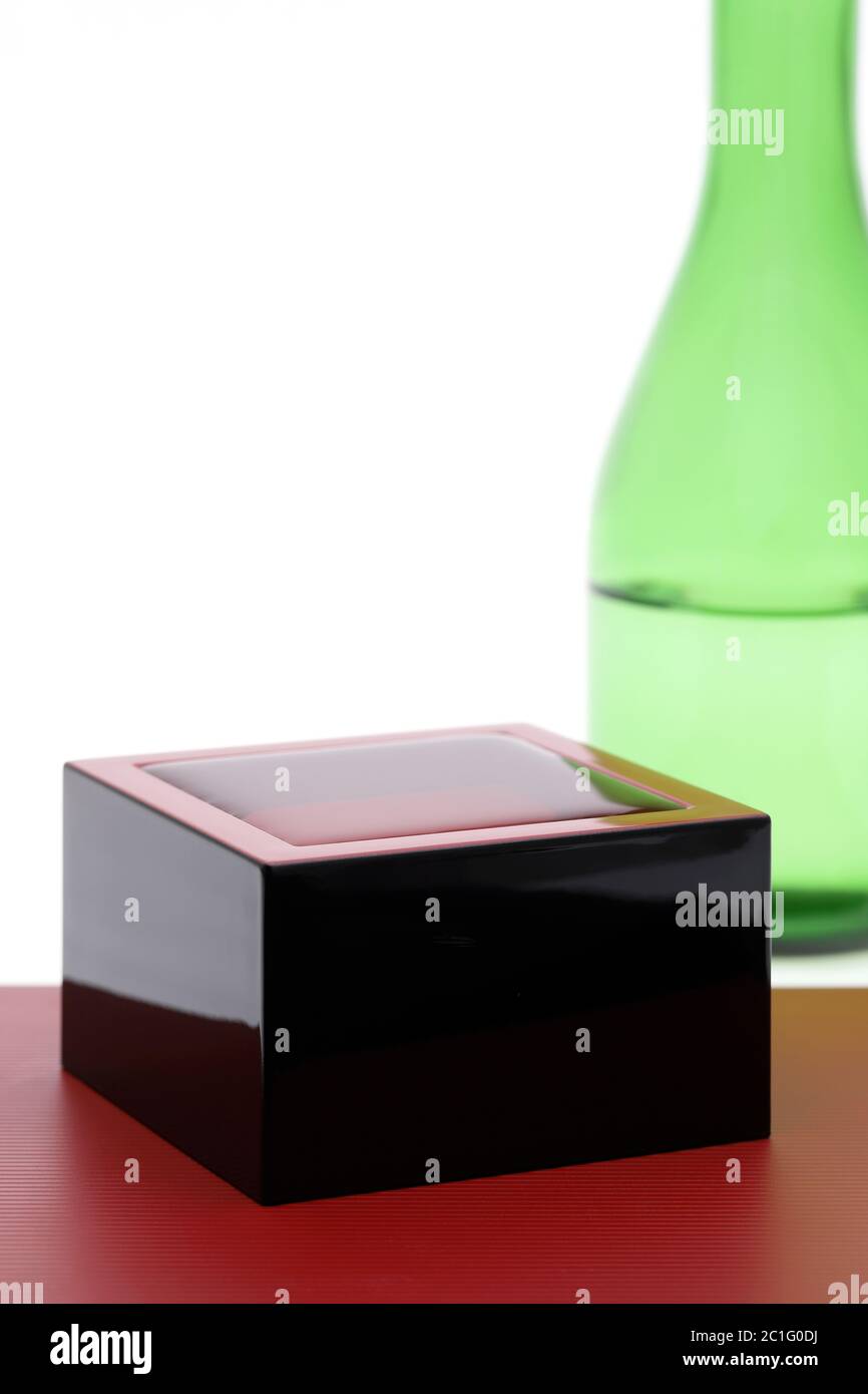 Japanese wooden box masu with sake isolated on white background Stock