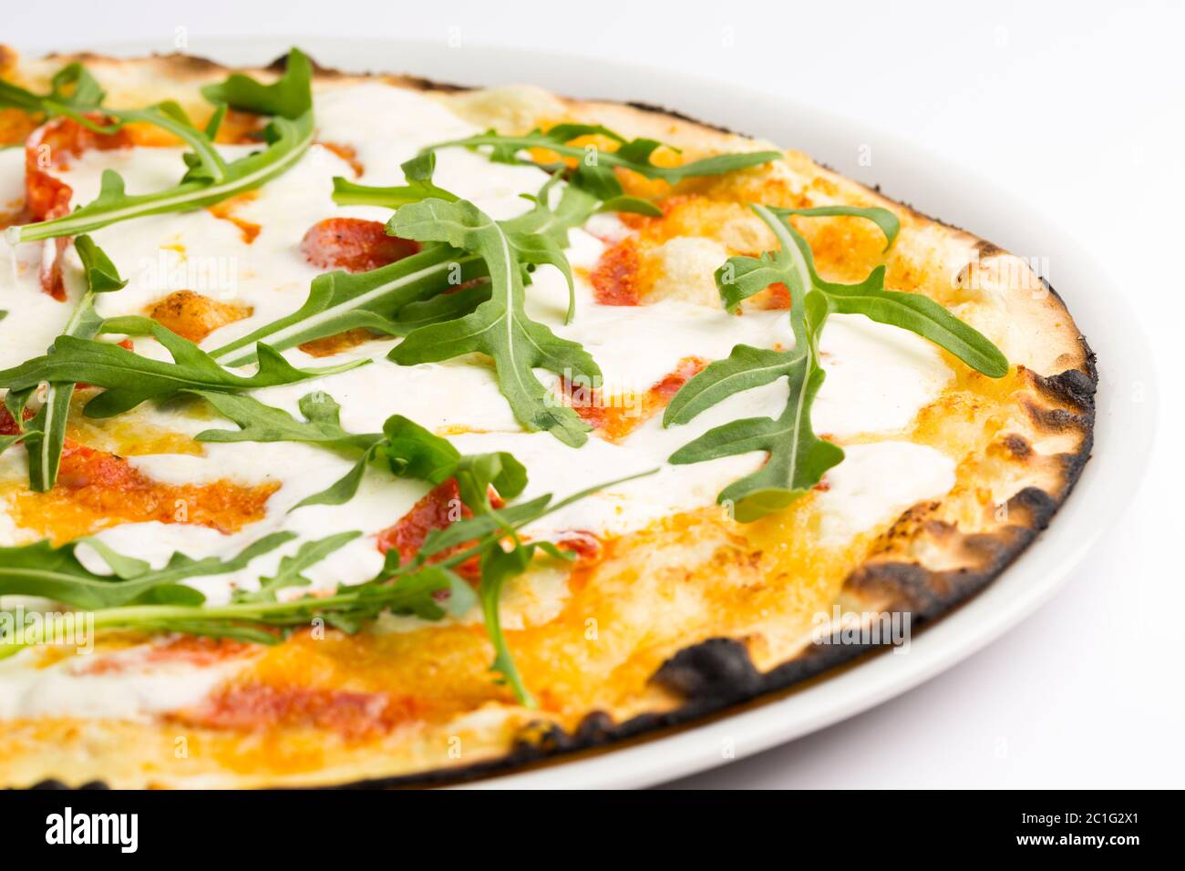 Pizza with capocollo, rocket, sauce and stracciatella Stock Photo Alamy