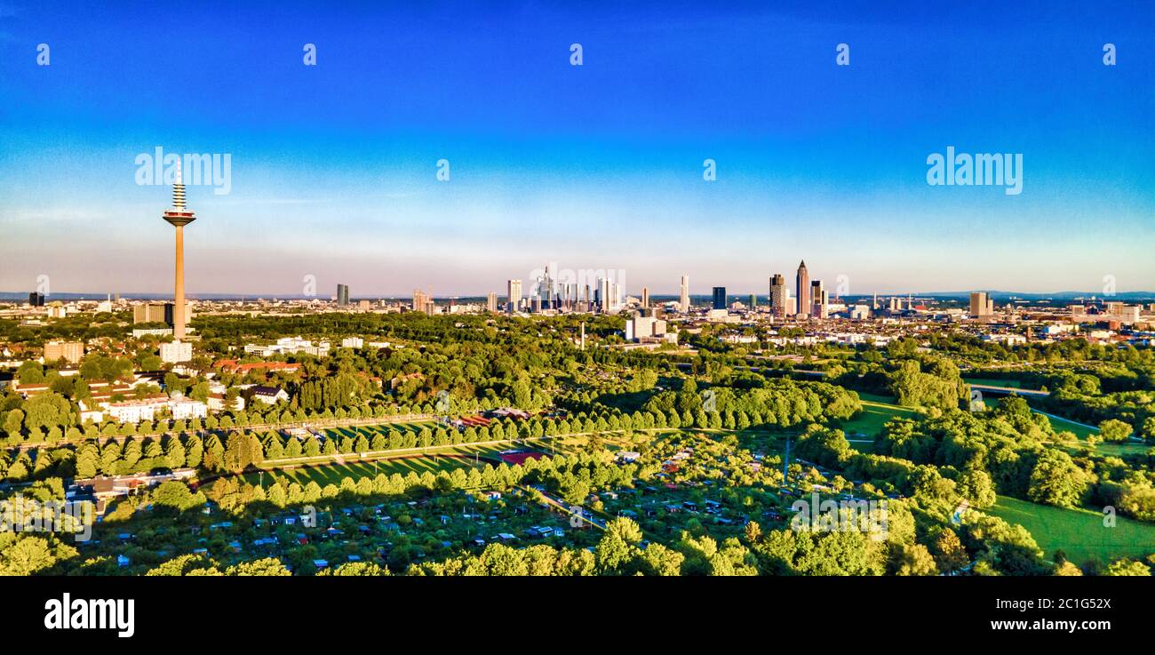 Beautiful aerial view on european finance center city Frankfurt am Main downtown skyline in spring.  Blue sky, clouds, green trees. Hesse, Germany. Stock Photo