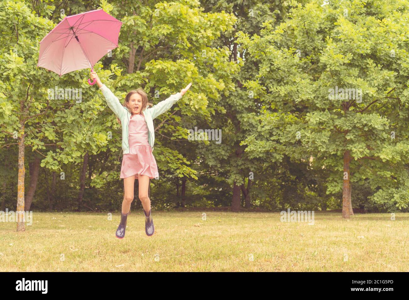 Happy girl with umbrella having fun Stock Photo - Alamy
