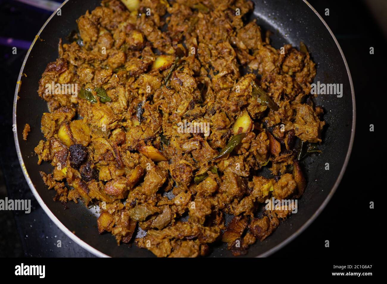 South Indian dish spicy beef fry Kerala, India. side dish ghee rice, appam, parotta, puttu, bread and chappathi, Kerala cuisine ,Buffalo roast / Meat Stock Photo