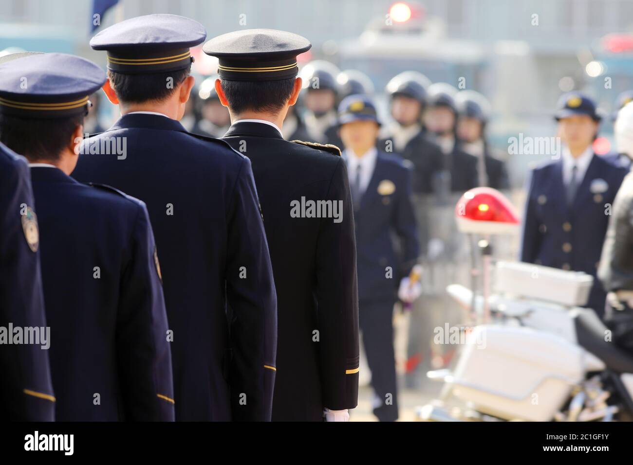 Japanese police officers stand in a row, attention Stock Photo
