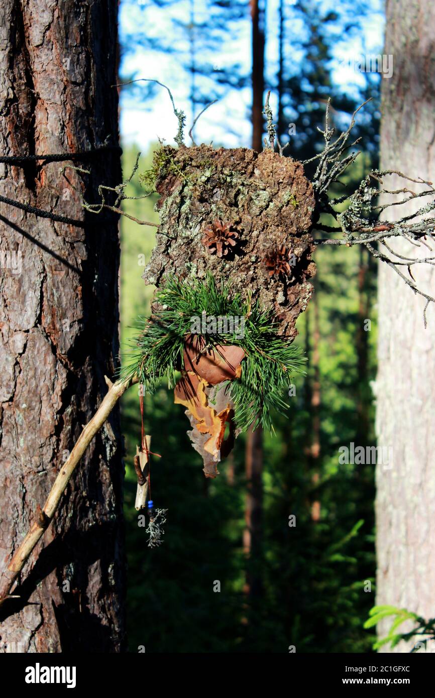 a forest idol from bark stick and pine cones made to coax the spirits. paganism Stock Photo