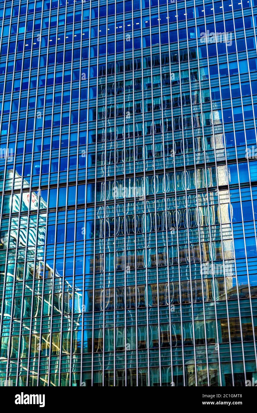 Reflection of Canada One Square skyscraper in a glass skyscraper facade, Canary Wharf, London, UK Stock Photo