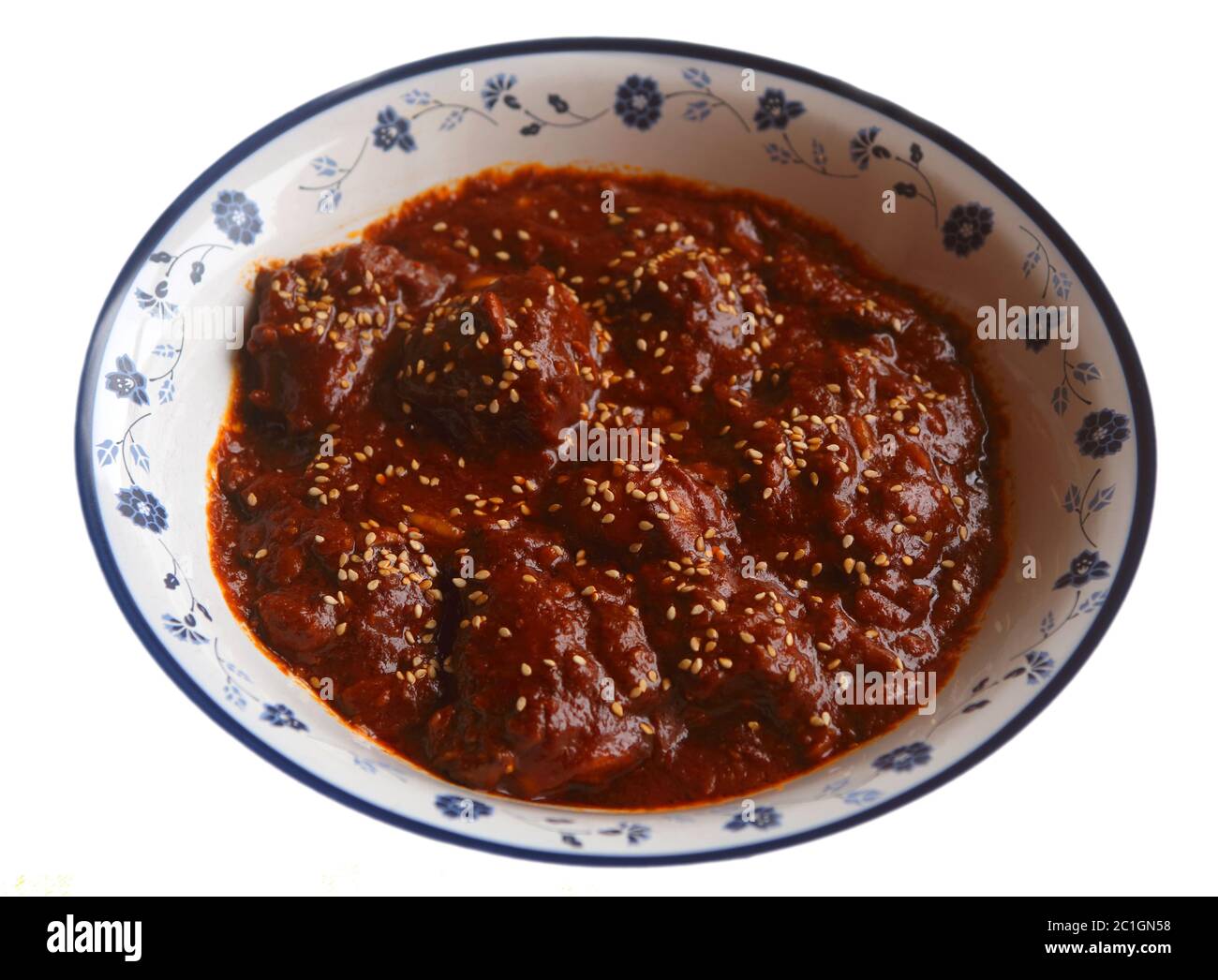 Chicken in spicy chocolate Mole Poblano sauce - famous typical Mexican dish from Puebla. (selective focus) Stock Photo