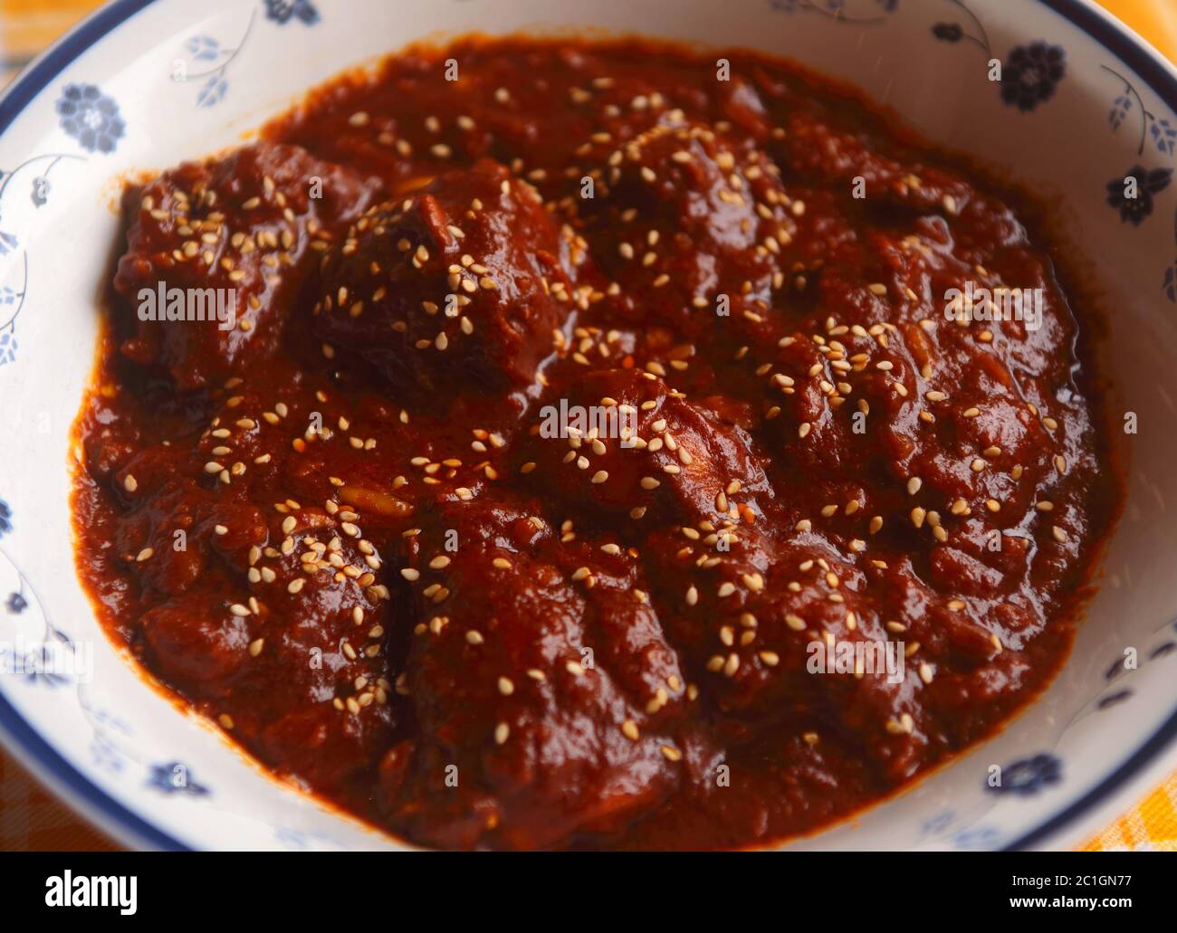 Chicken in spicy chocolate Mole Poblano sauce - famous typical Mexican dish from Puebla. (selective focus) Stock Photo