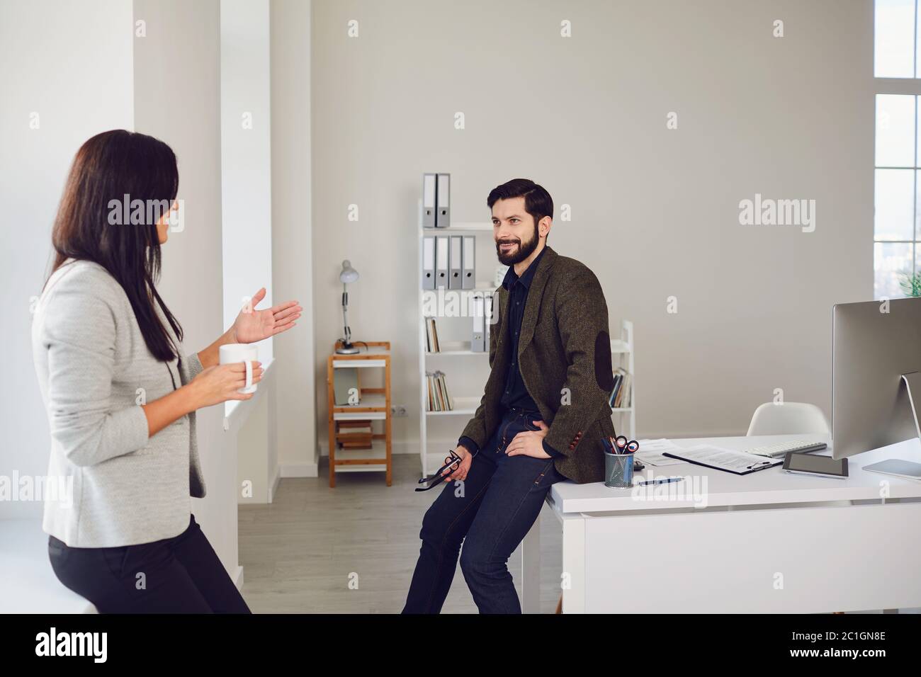 Business people talking in a white office. Stock Photo