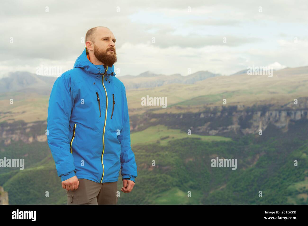 Rugged bearded man in in a membrane jacket headshot country masculine midwest mountain male Stock Photo