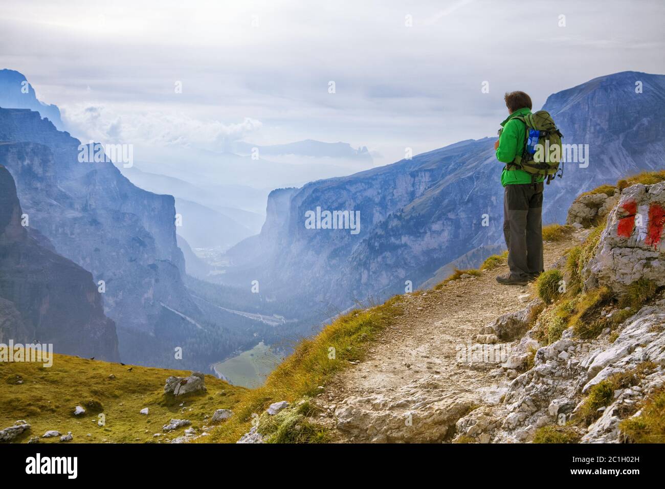 Young adventurer standing on a cliff Stock Photo - Alamy