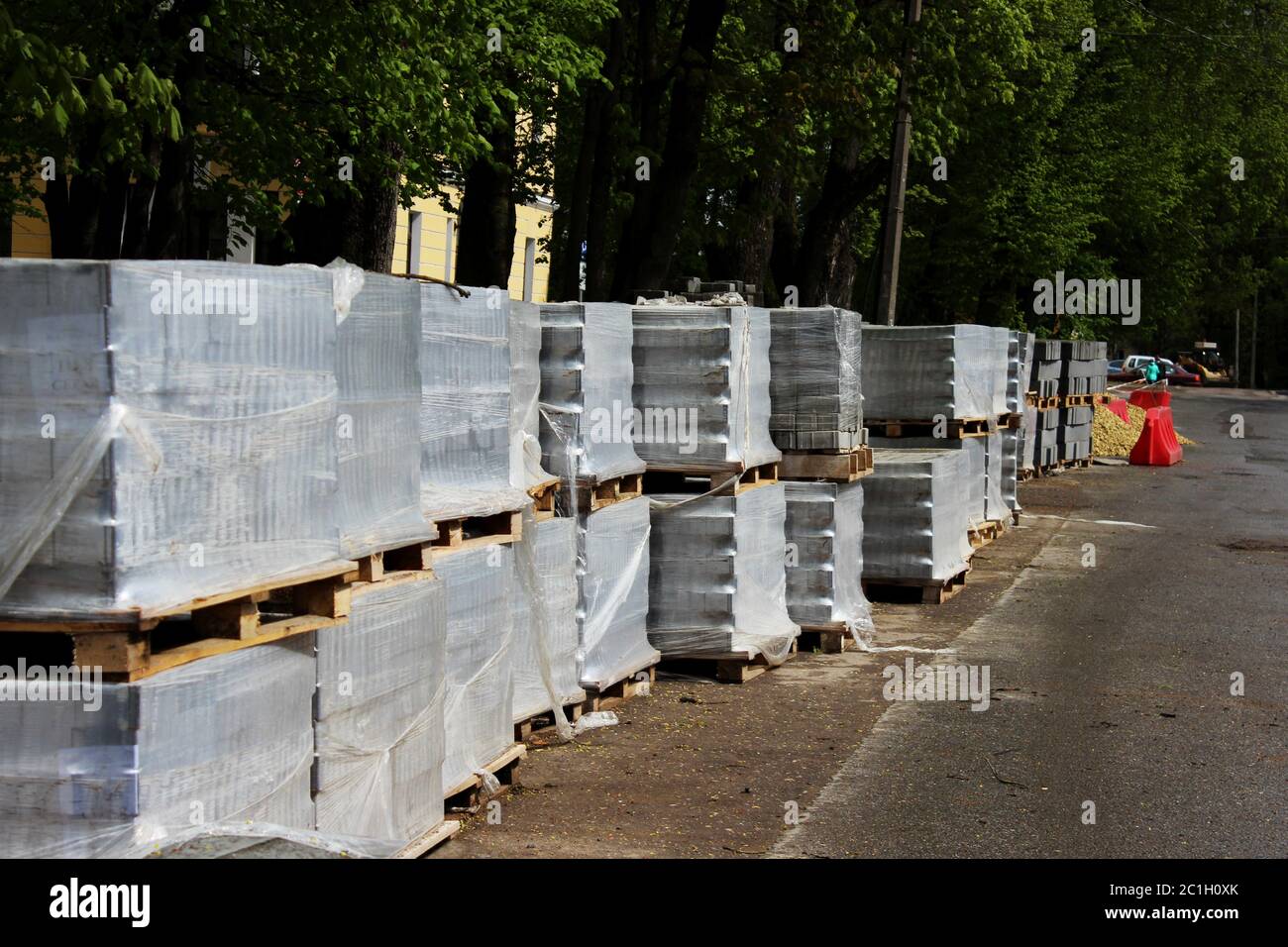 Grey paving slabs folded on a pallets during the reconstruction and repair of the square in the city Gatchina. Stock Photo