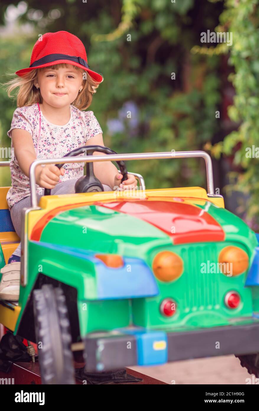 Little girl driving a toy car Stock Photo - Alamy