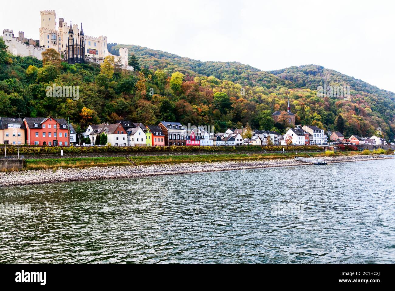 A long row of picturesque houses on the Rhine shore beneath the castle Stolzenfels in historic city Koblenz, Germany Stock Photo