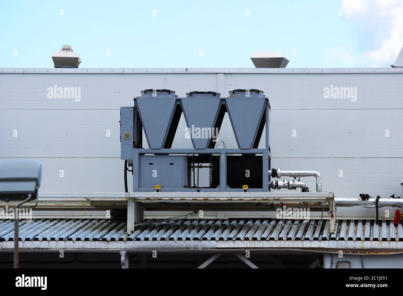 central air-conditioning system on the roof of a huge city shopping center. Stock Photo