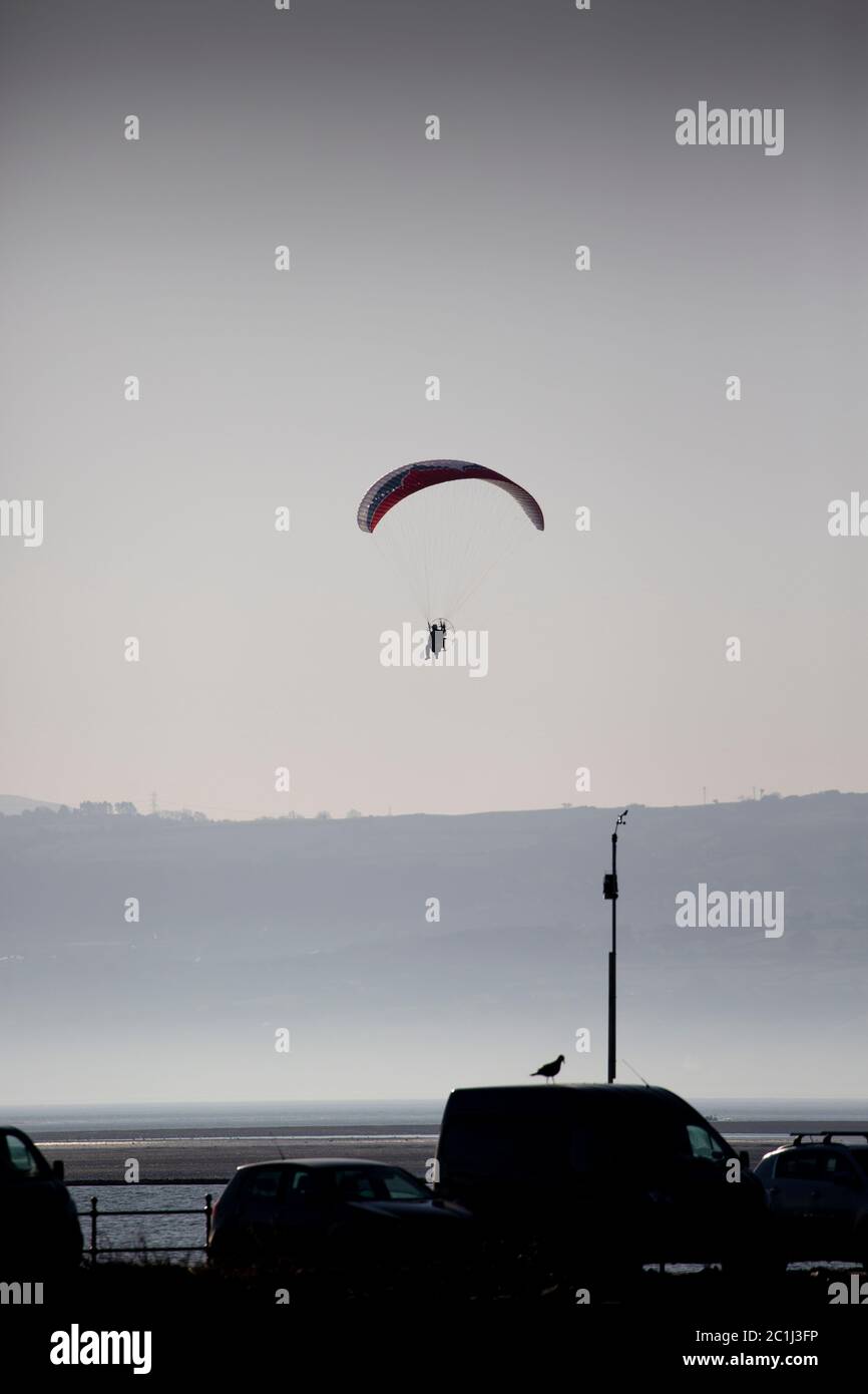 Paraglider Over the Dee Estuary in Summer Mist Stock Photo