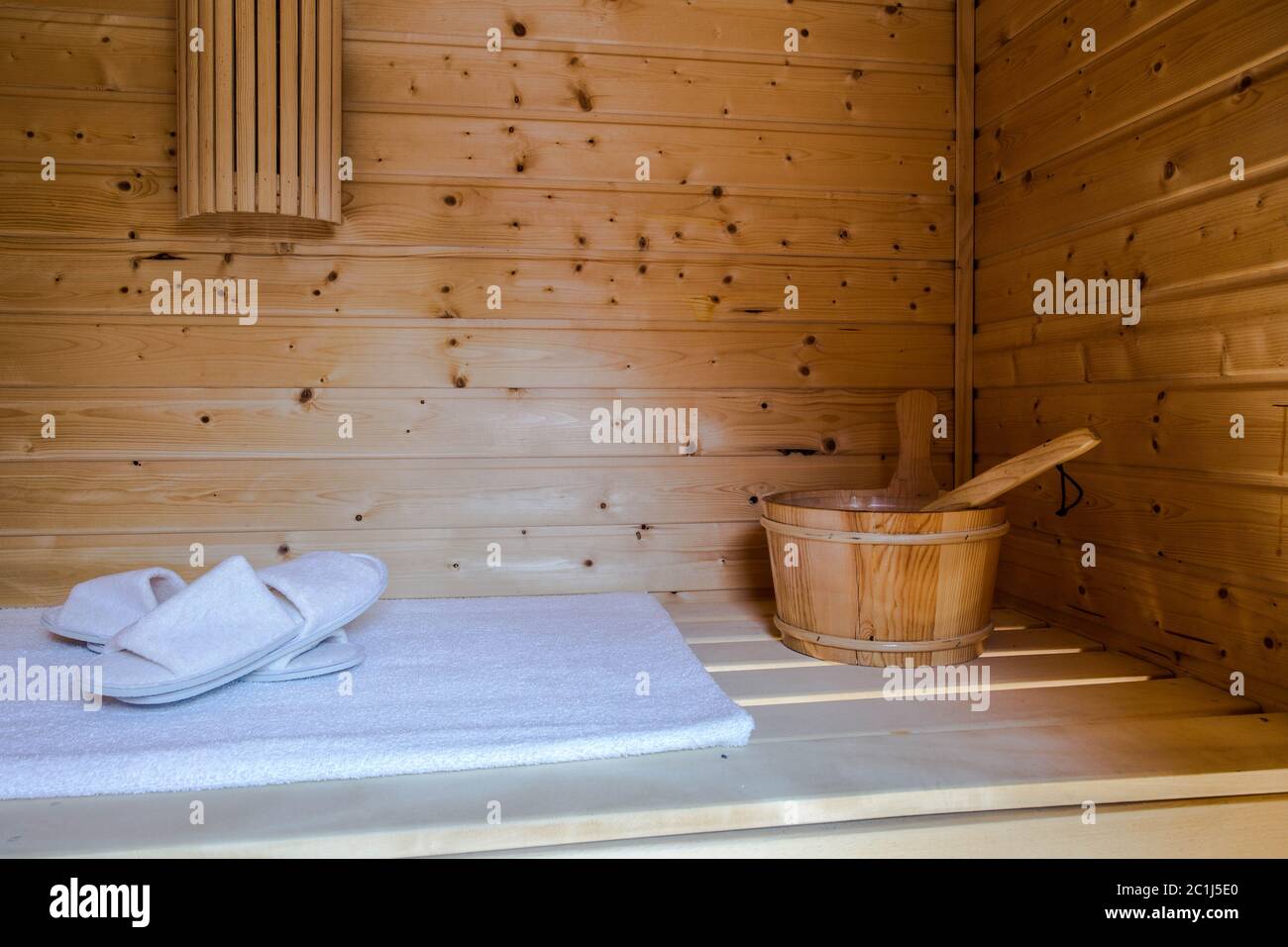 A healthy wooden hot sauna with sauna accessories Stock Photo