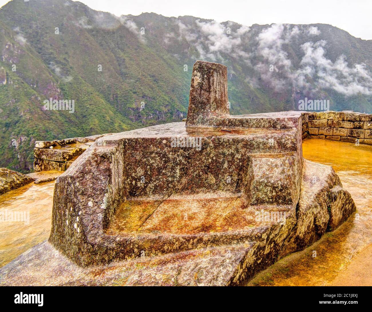 Intihuatana stone as an astronomic clock or calendar by the Incas in Machu Picchu archaeological site with Polygonal masonry, Cu Stock Photo