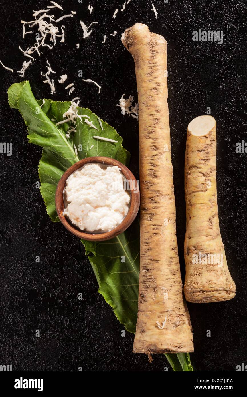 Horseradish root and grated horseradish on black background Stock Photo ...