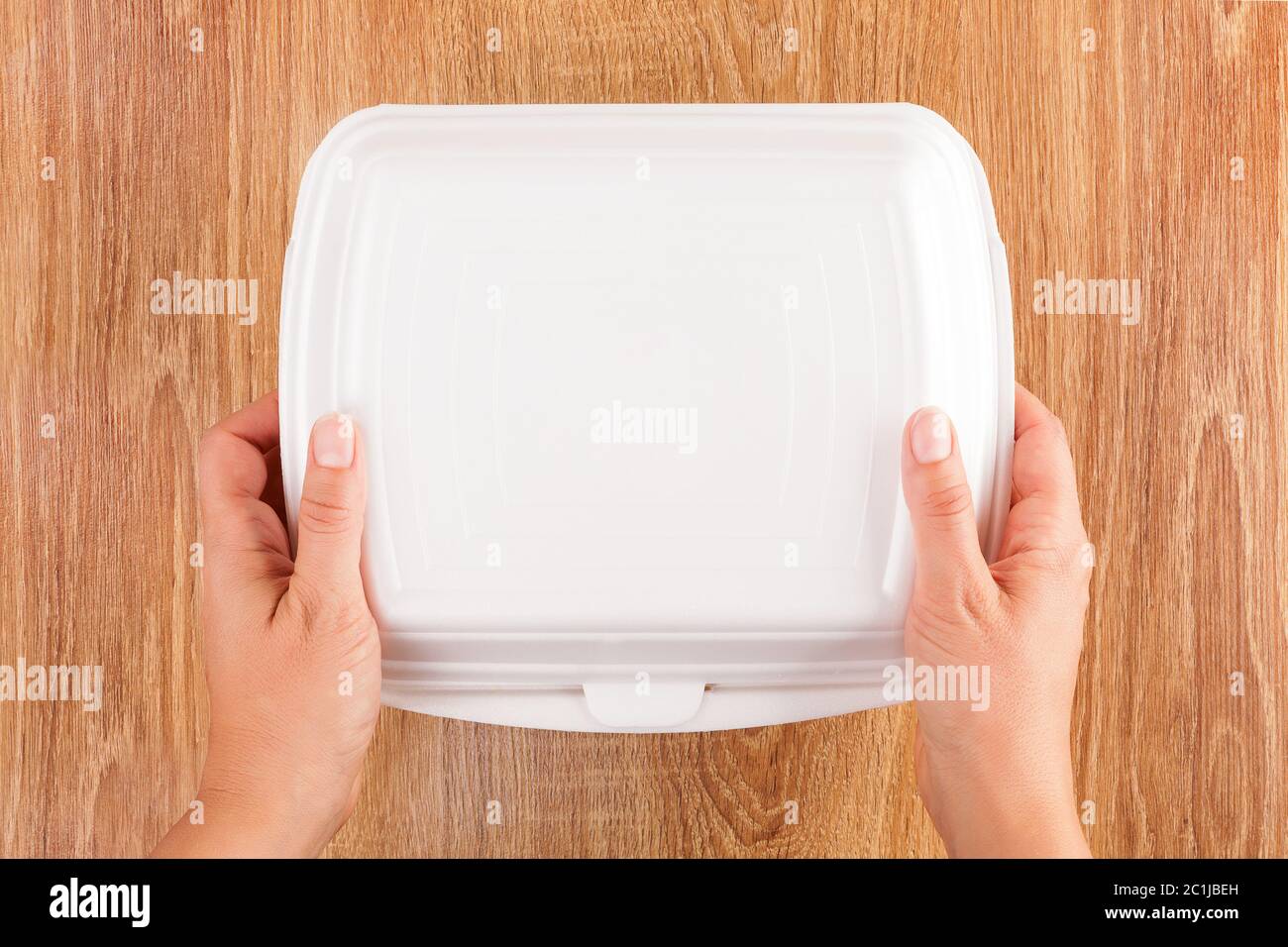Closed take away box holding in hands Stock Photo