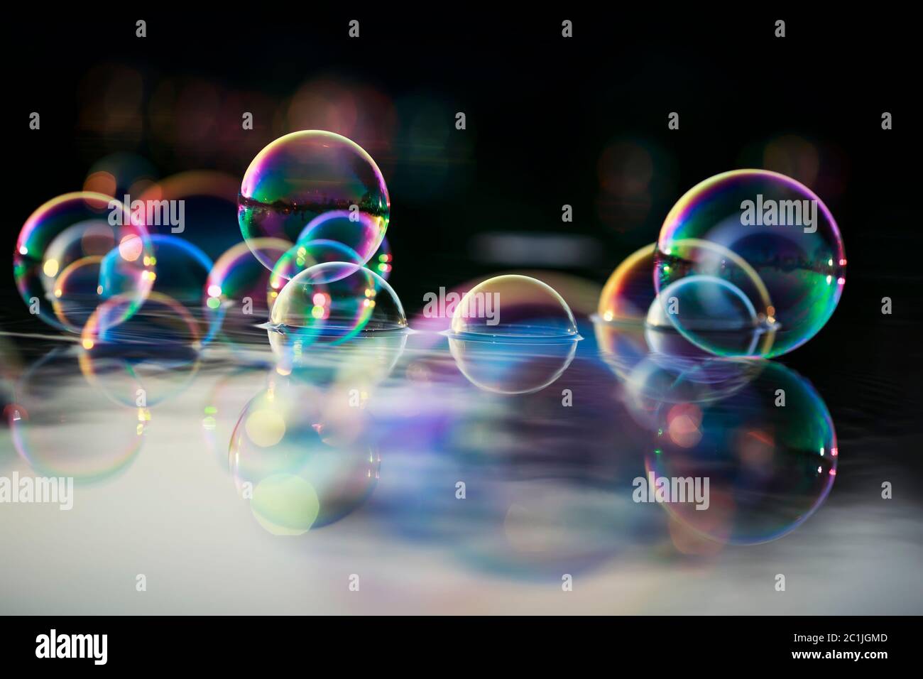 background with many sparkling iridescent soap bubbles float on the ...