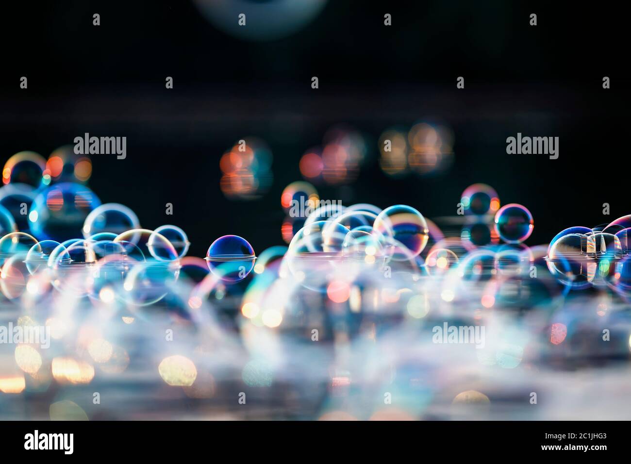 fairy background with lots of shiny iridescent soap bubbles float on ...