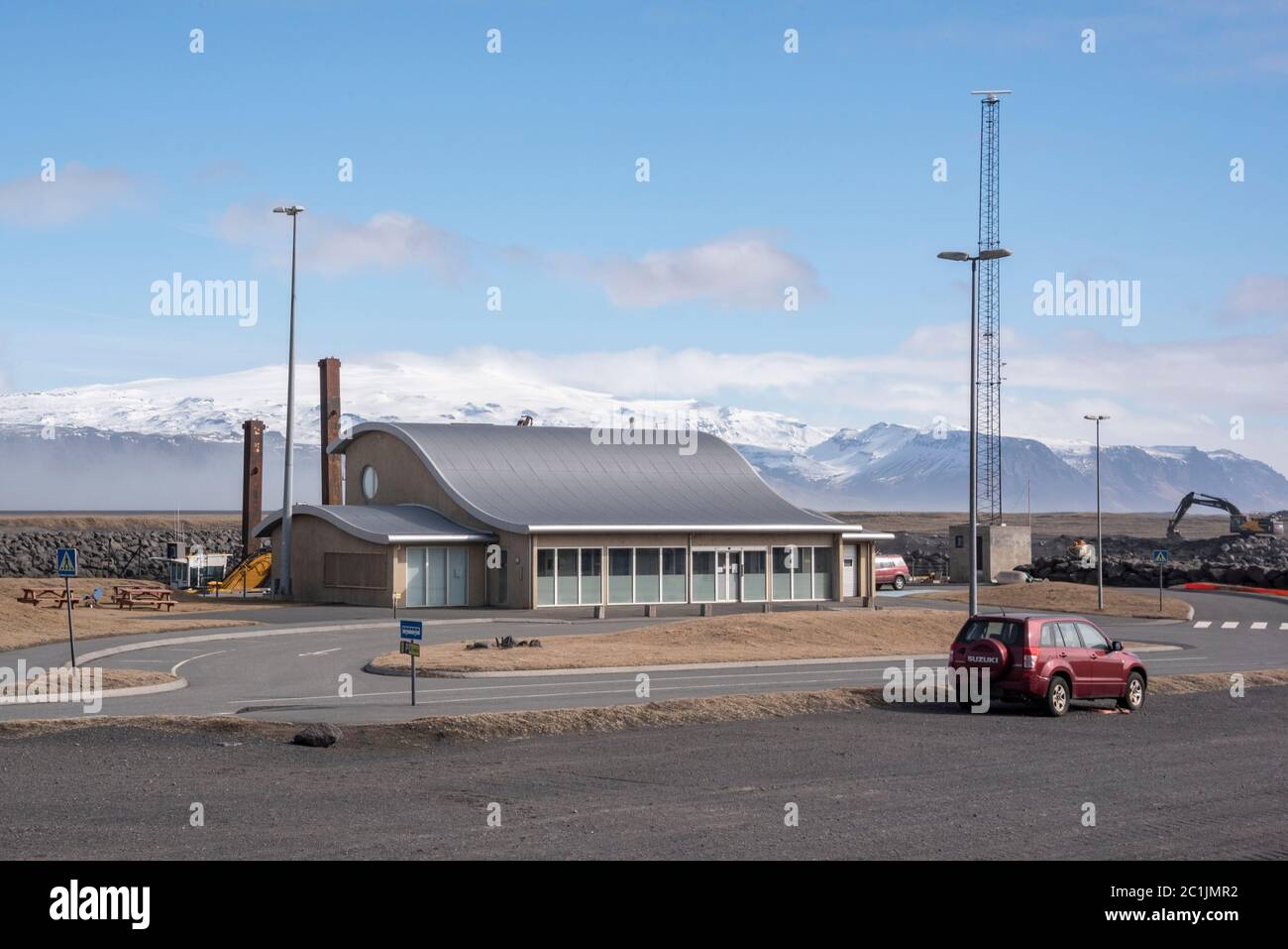 Terminal building at Landeyjahöfn, South Iceland. Ferries sail from here to the Westman Islands.A dust storm blows across beyond the building. Stock Photo