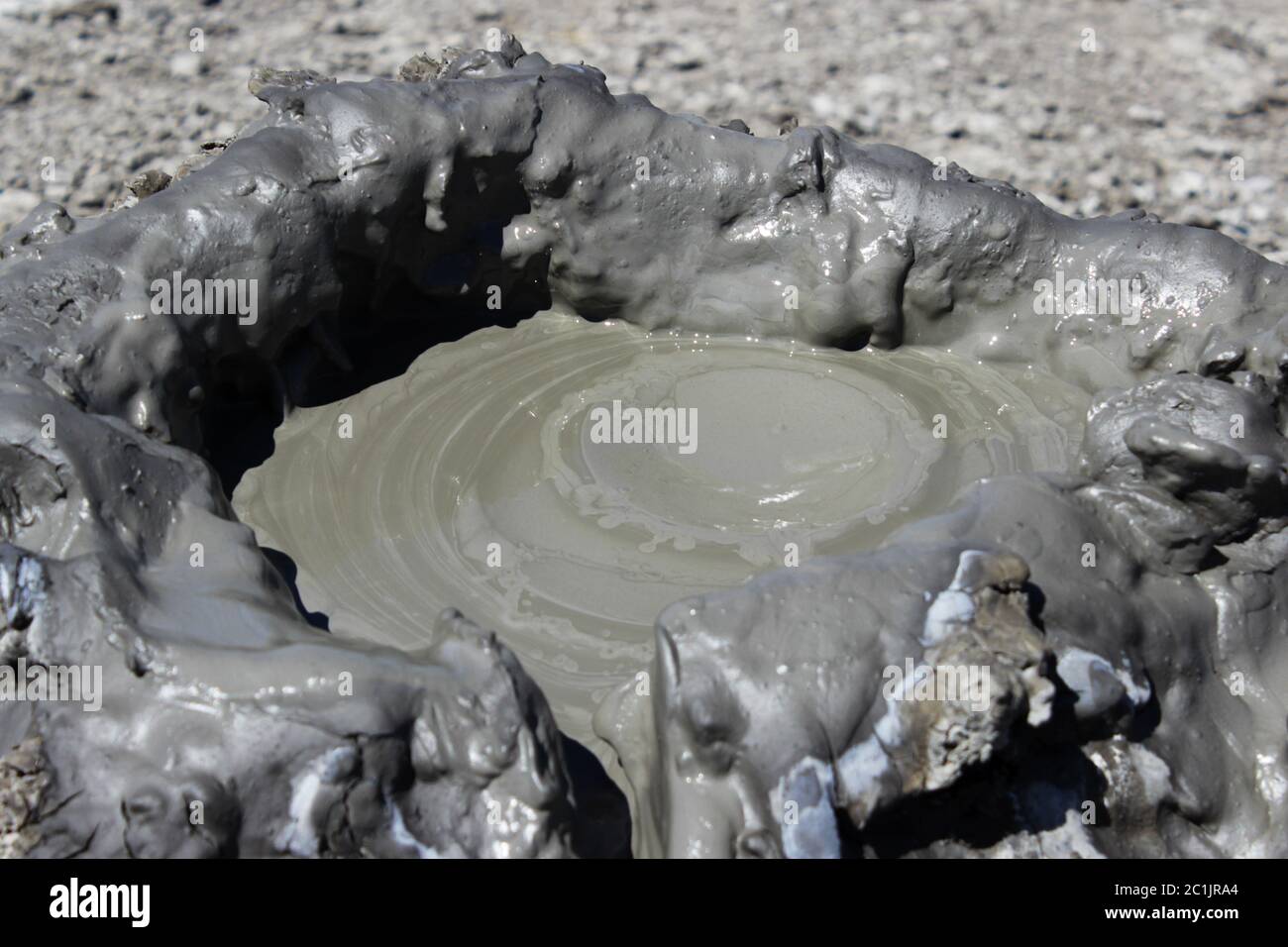 the top of a cold mud volcano, which is created as a result of the release of gas methane, nitrogen and carbon dioxide from the Stock Photo