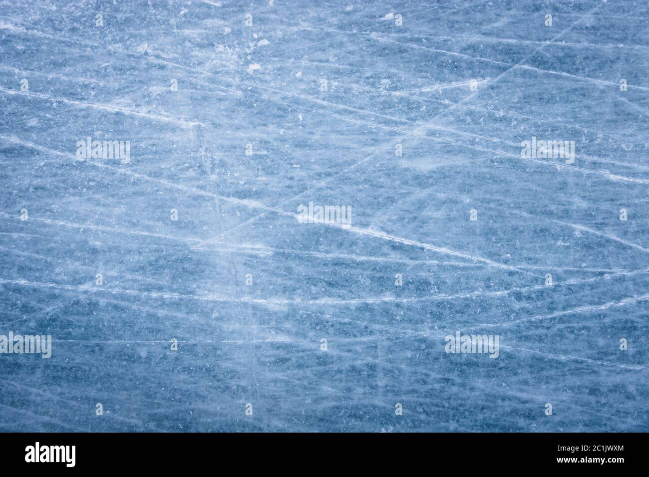 Skating ice rink texture covered in daylight.Close up of blue ice rink floor, copy space. Perfectly polished artificial ice Stock Photo
