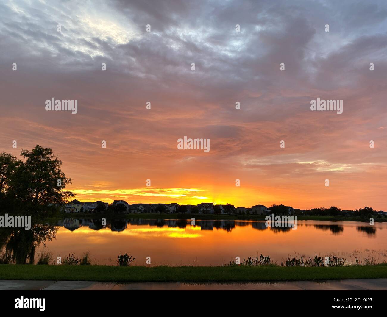 Beautiful pink, orange and blue sunset reflecting on a lake in a ...