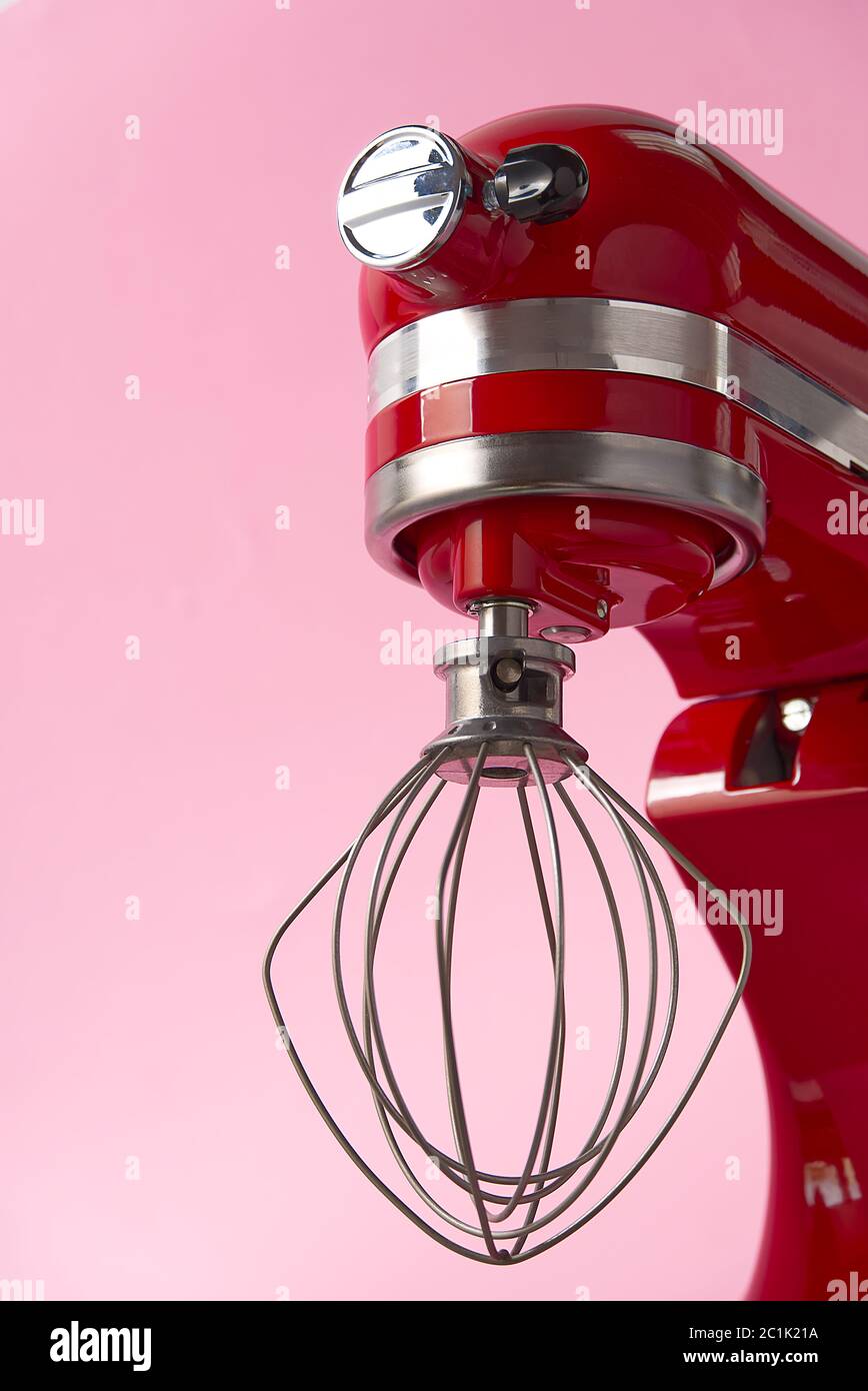 Stylish Red Kitchen Mixer With Clipping Path Isolated On pink Background. Professional steel