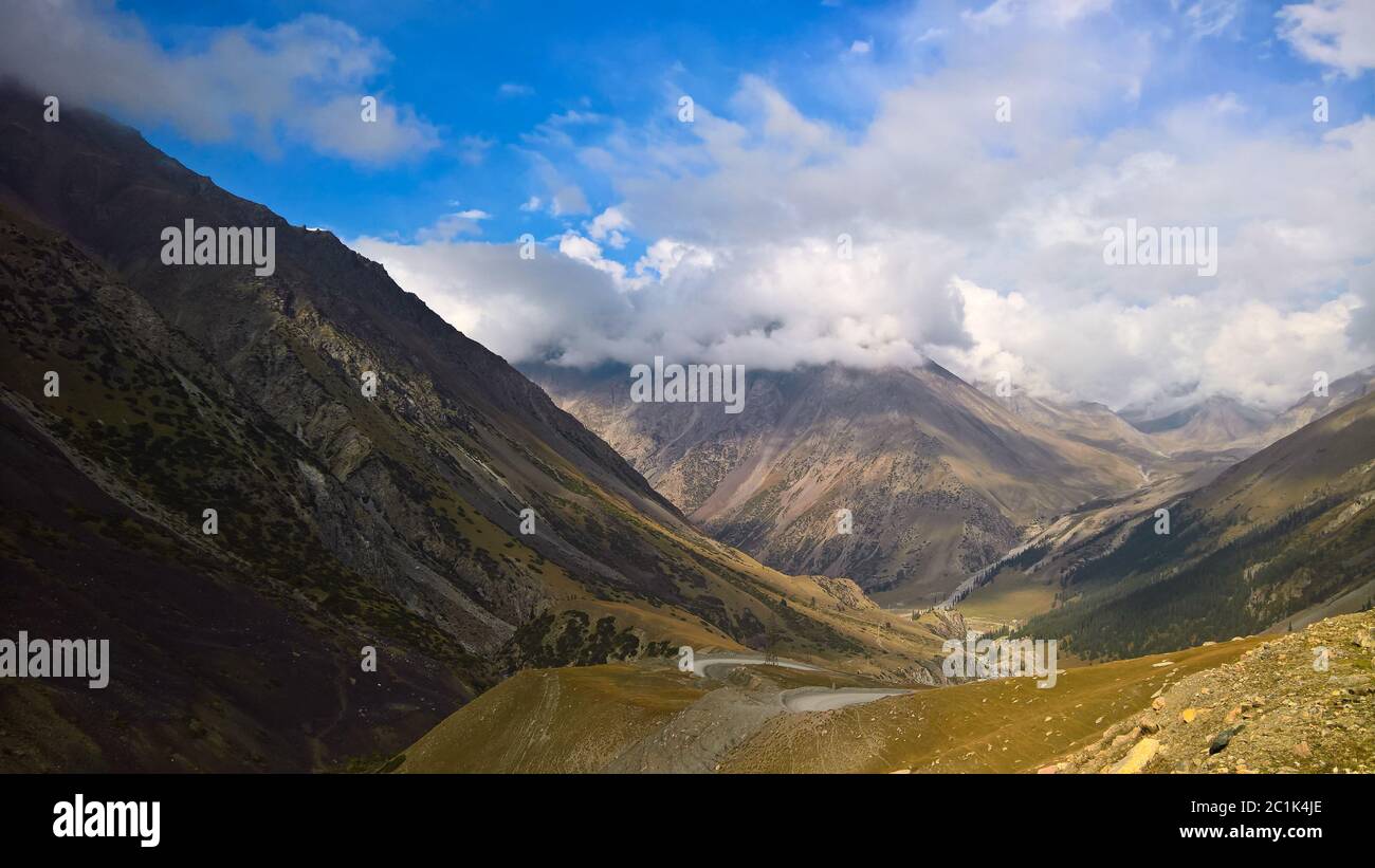 serpentine road to Barskoon pass, river and gorge and Sarymoynak pass, Jeti-Oguz, Kyrgyzstan Stock Photo