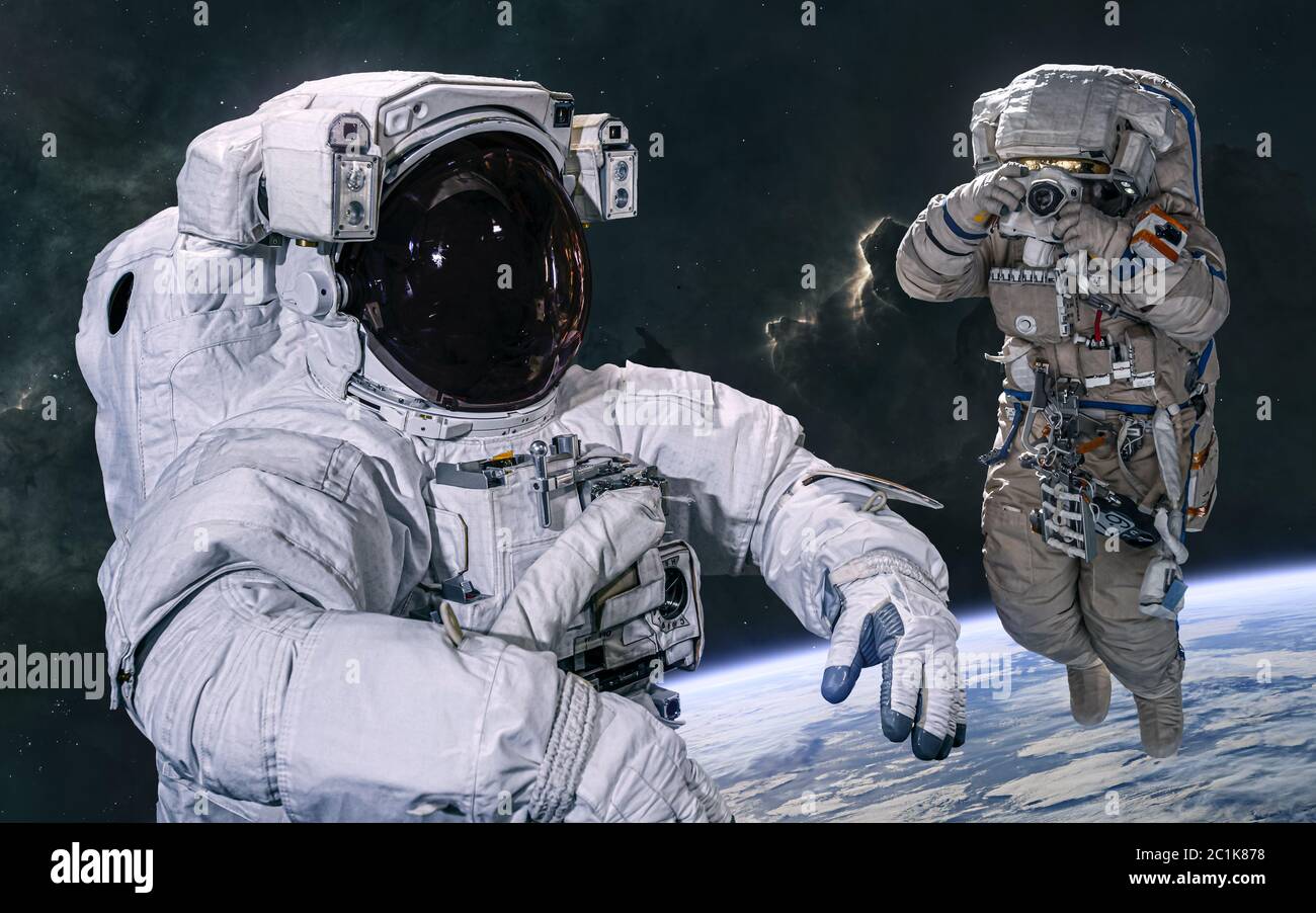 Astronauts in open space in orbit of Earth. Science fiction Stock Photo -  Alamy
