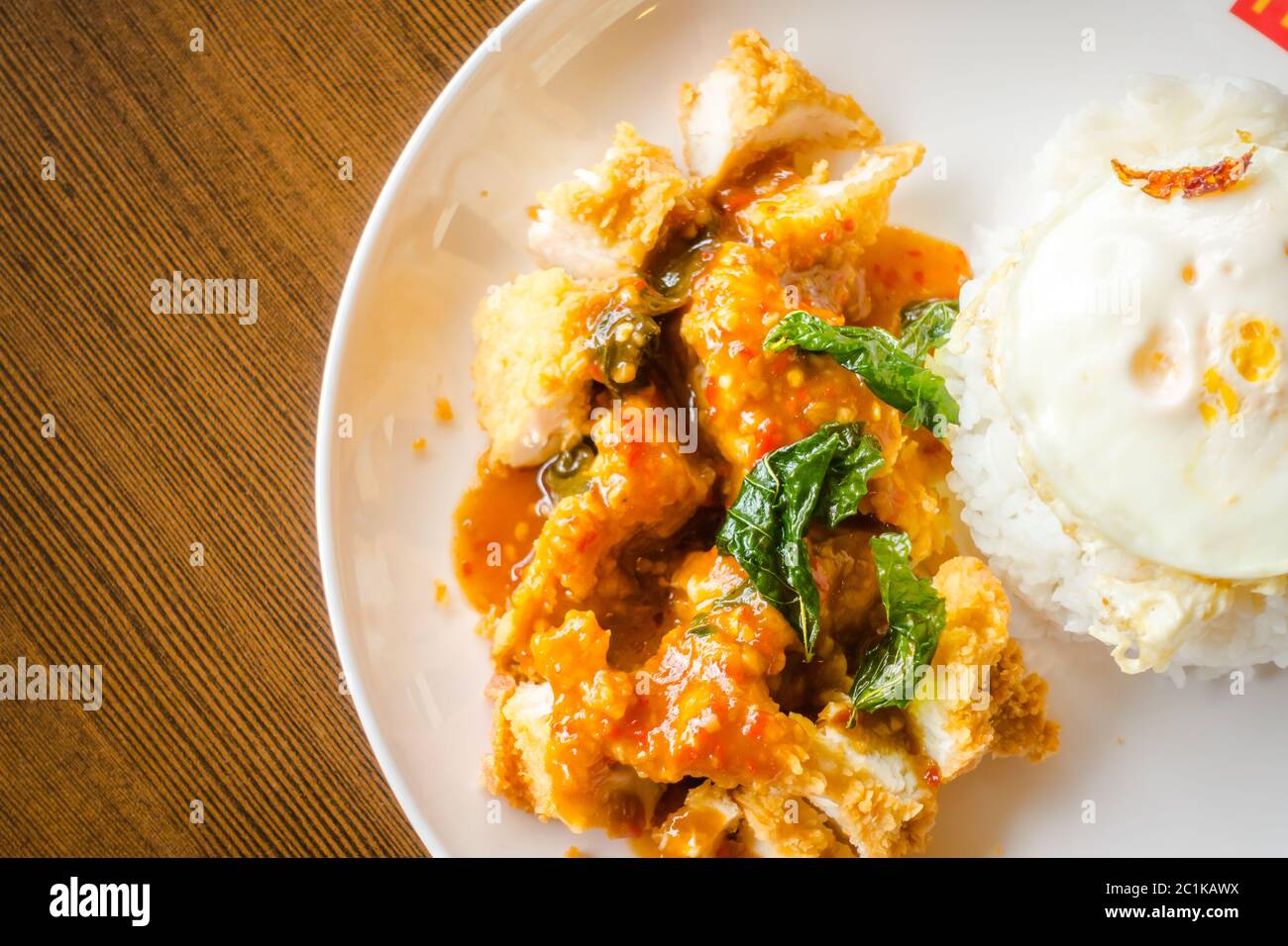 Rice with crispy chicken and fried egg Stock Photo