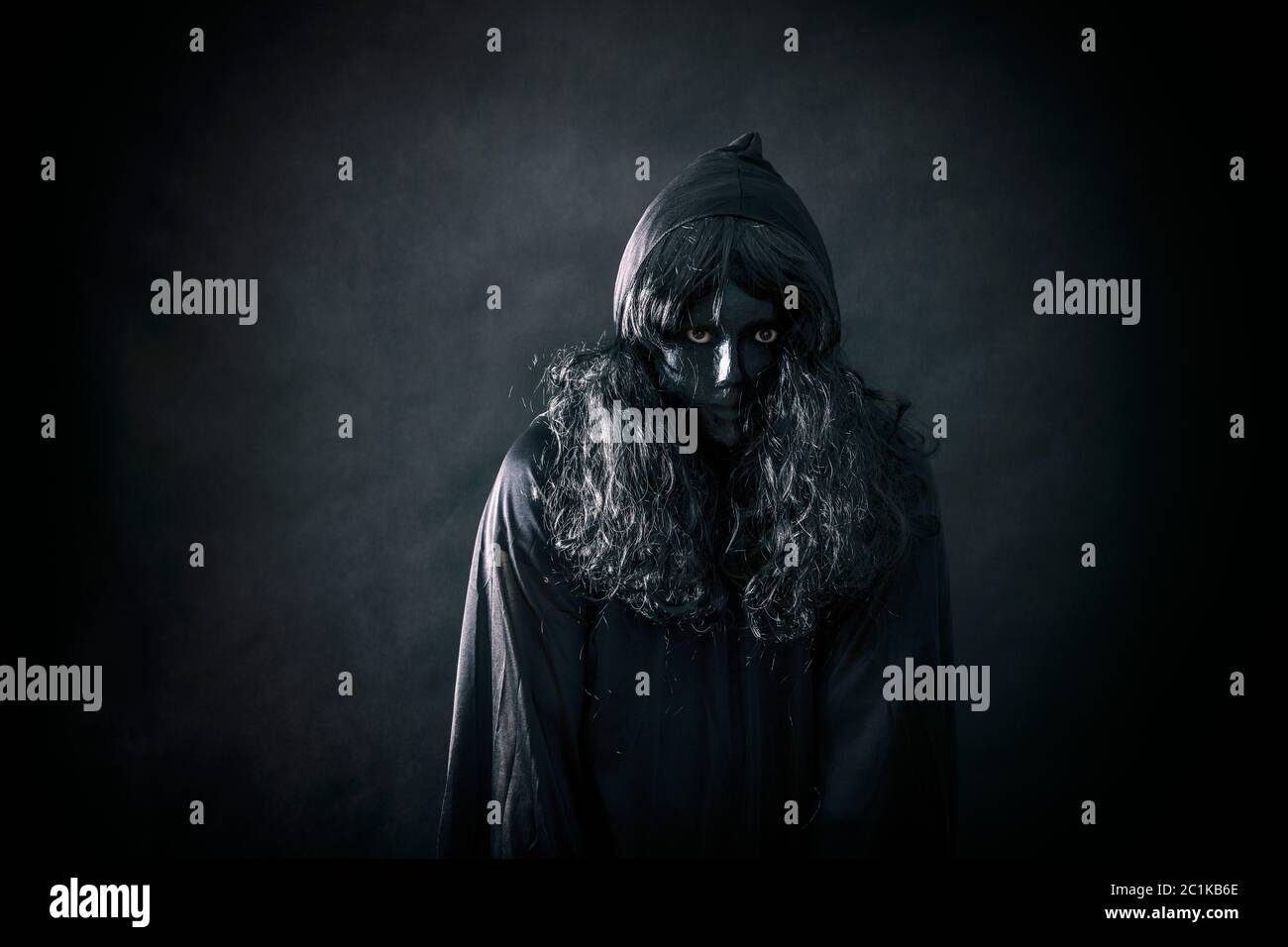 The witch in hooded cloak Stock Photo - Alamy