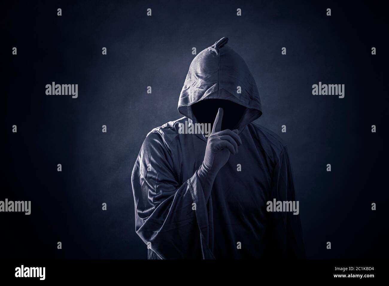 Scary figure in hooded cloak Stock Photo - Alamy