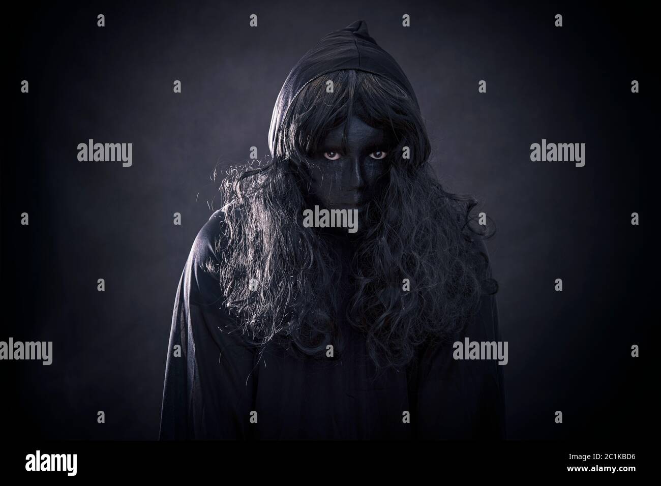 The witch in hooded cloak Stock Photo