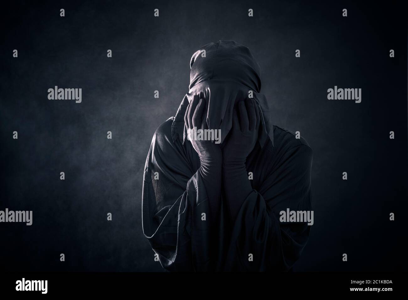 Scary figure in hooded cloak Stock Photo - Alamy