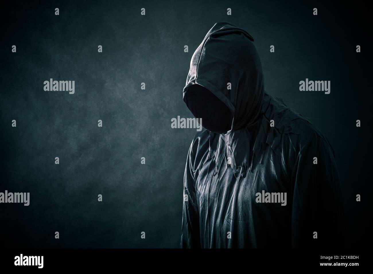 Scary figure in hooded cloak Stock Photo - Alamy