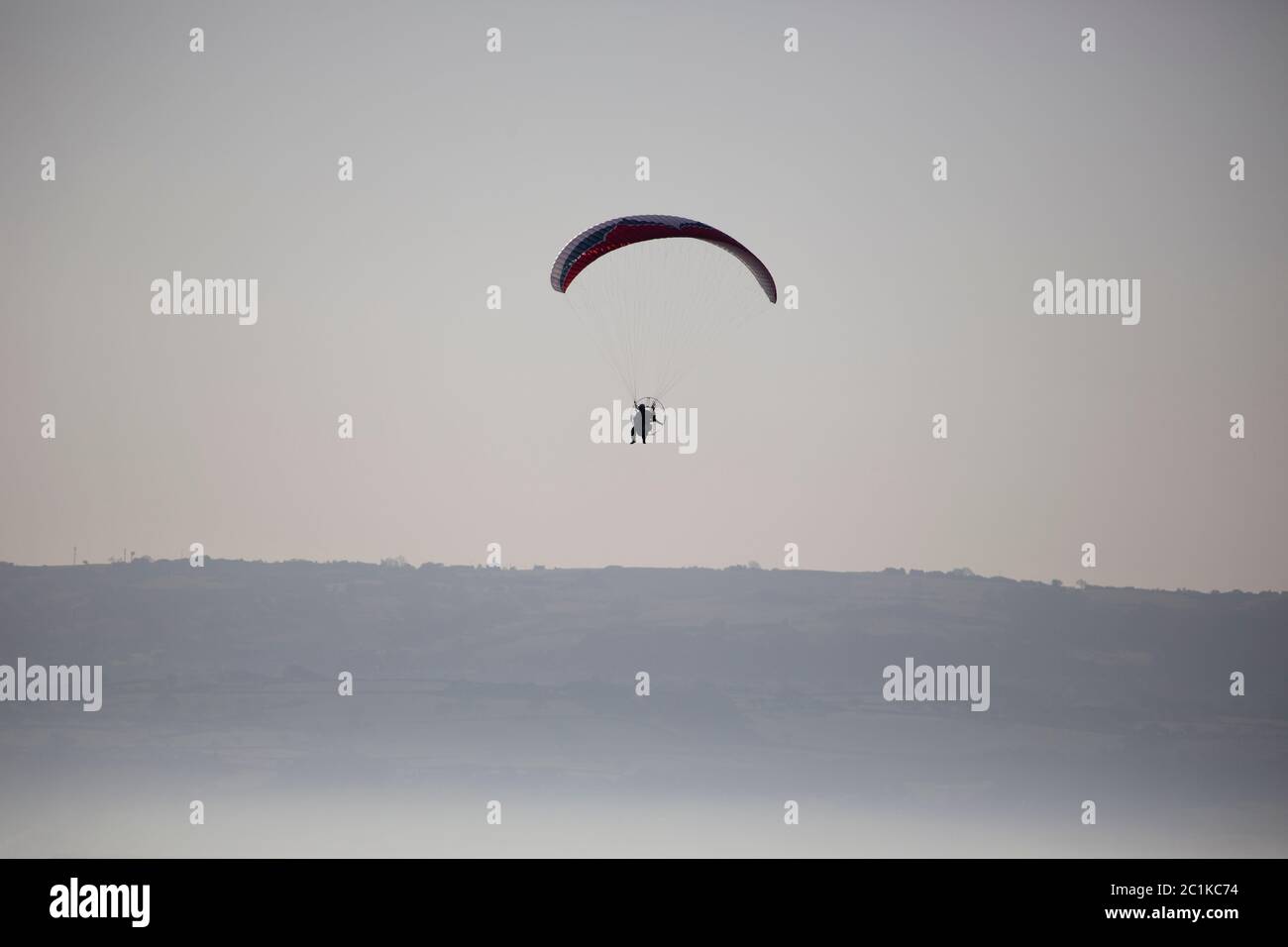 Paraglider Over the Dee Estuary in Summer Mist Stock Photo