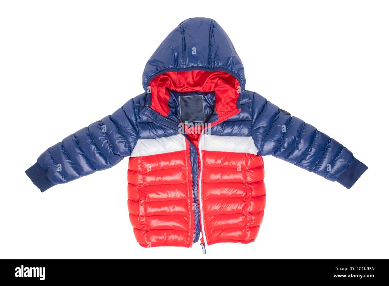Winter jacket isolated. A stylish blue and red warm down jacket with red lining for the kids is isolated on a white background. Childrens wear with hood for spring and autumn. Stock Photo