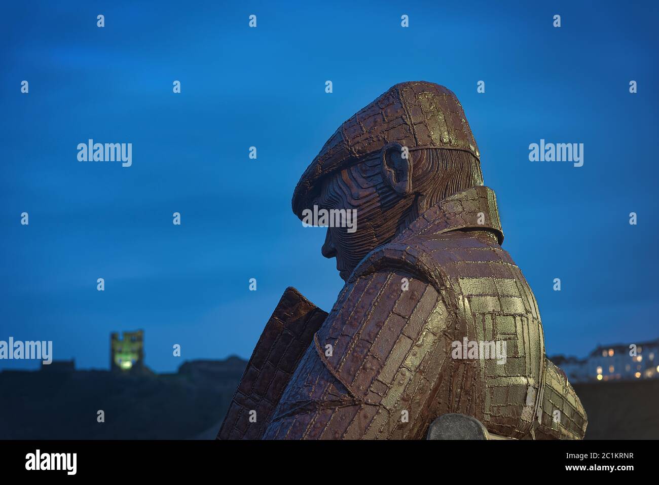 Scarbourough, UK - MArch 2020:  'Freddie Gilroy and the Belsen Stragglers' is a giant steel structure made by Ray Lonsdale. He sits in is overcoat an Stock Photo