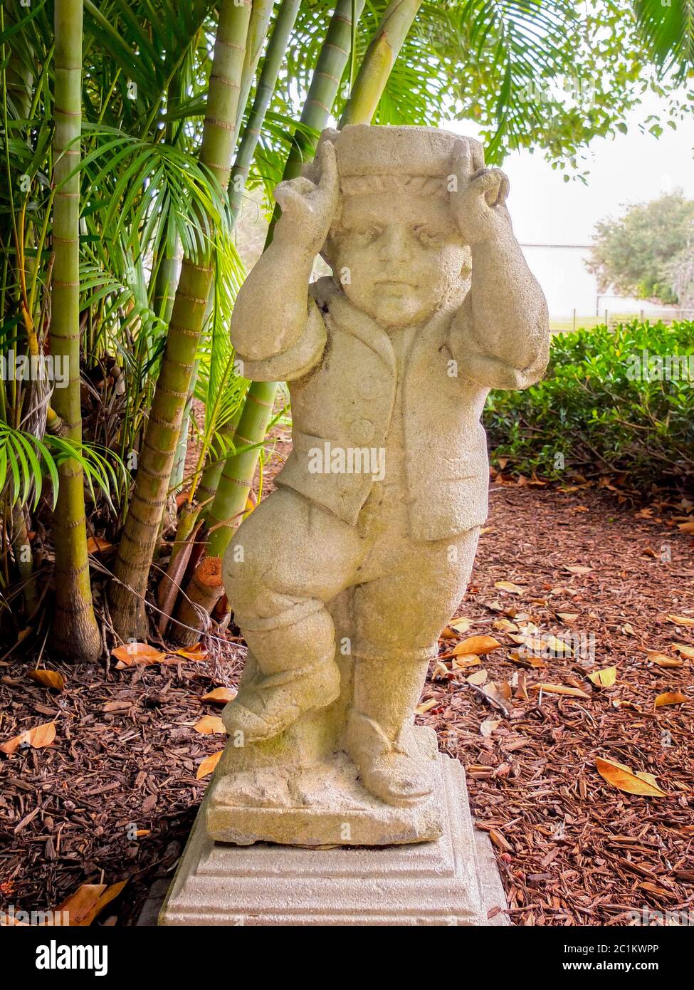 A historic statue of a dwarf is exhibited in the Dwarf Garden of the John and Mable Ringling Museum in Sarasota, FL, part of a European collection of Stock Photo