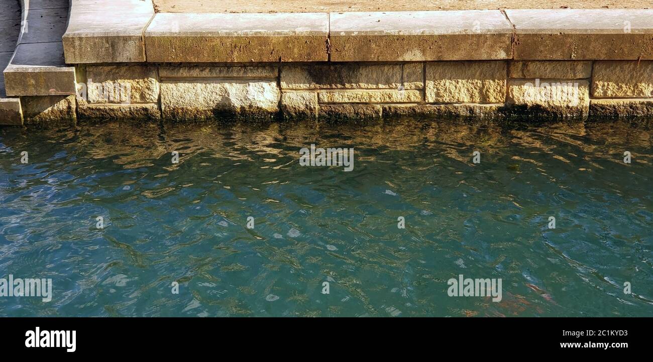 Stone retaining wall water body Stock Photo Alamy