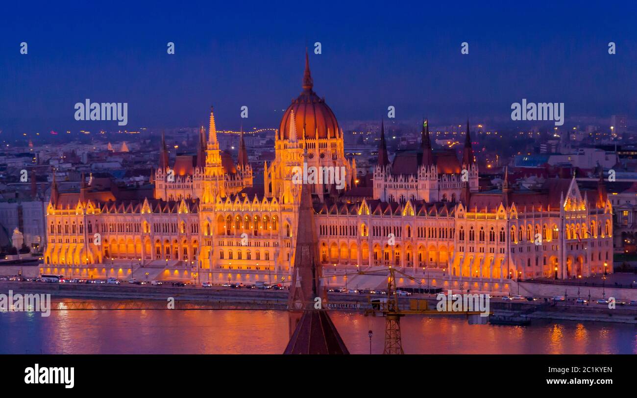 Hungarian Parliament Building In Evening Sunset Illuminated With Red 